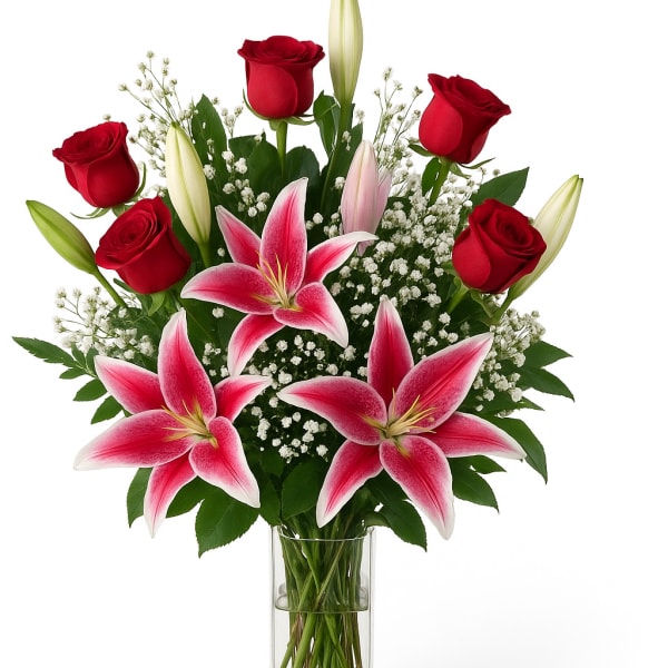 Red roses and pink lilies in a clear glass vase