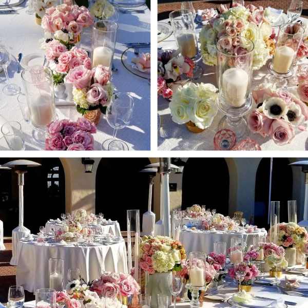 Pink and white rose centerpieces with candles on a decorated table