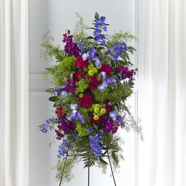 Tall standing floral spray with purple, blue, and green flowers