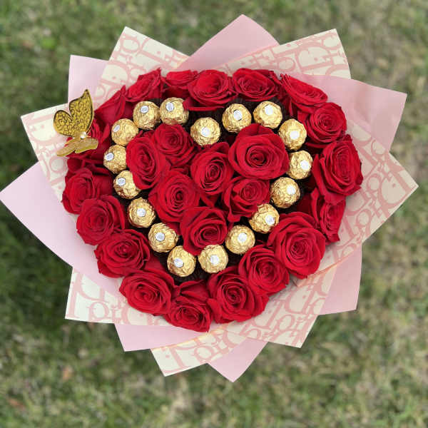 Heart-shaped bouquet of red roses with gold-wrapped chocolates