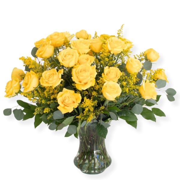 Yellow roses arranged in a clear glass vase