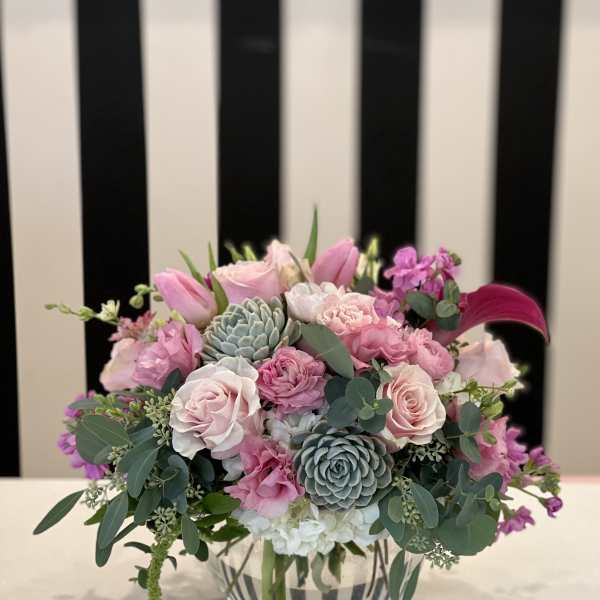 Pink and white floral arrangement in a clear glass vase