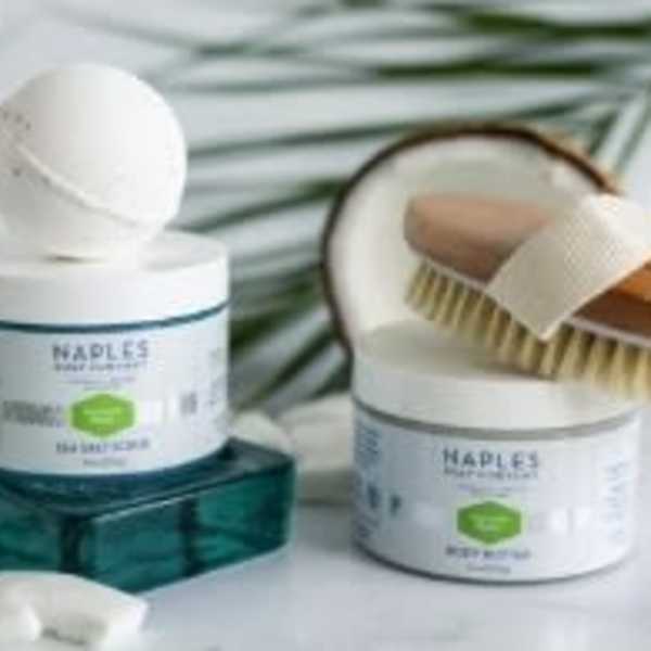 Two hair care jars with a brush and comb on a white surface