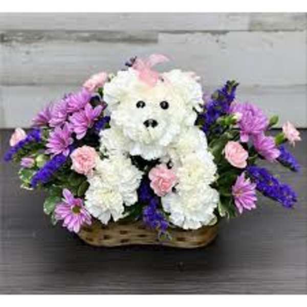 White floral teddy bear in a basket with pink and purple flowers