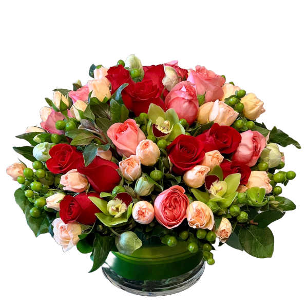 Mixed roses and orchids in a green glass vase