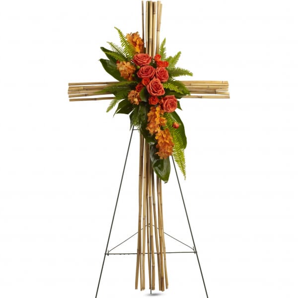Orange roses and orchids arranged on a bamboo cross easel