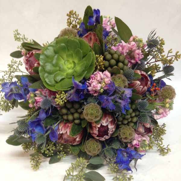 Mixed bouquet with blue and pink flowers and a large green succulent