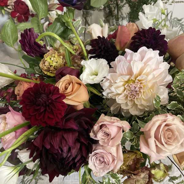 Mixed bouquet of roses, dahlias, and white blooms in pink, burgundy, and cream