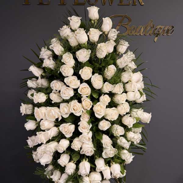 Large standing spray of white roses on an easel