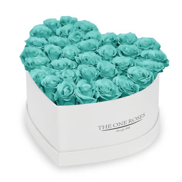 Heart-shaped box filled with turquoise roses