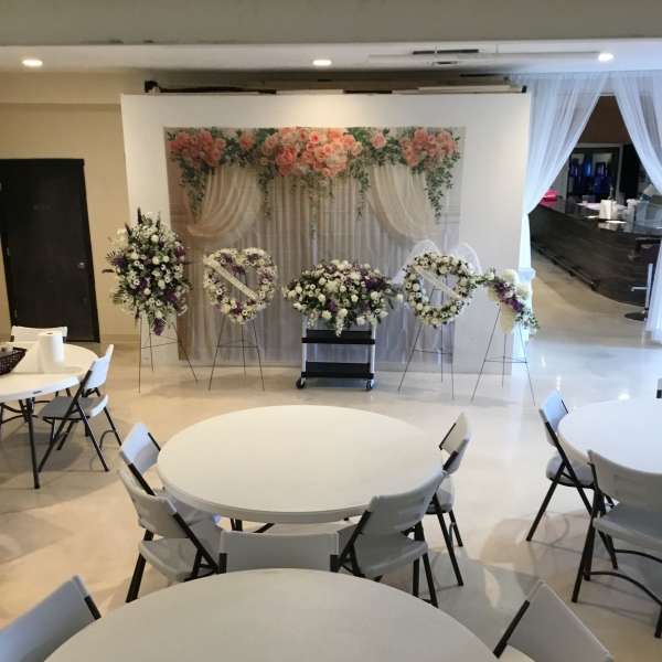 Wedding floral display with pink and white arrangements on stands
