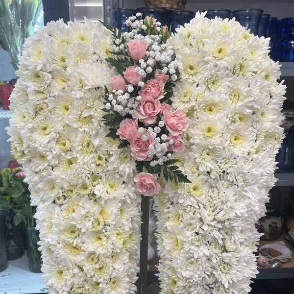 White chrysanthemum standing spray with pink roses and baby's breath