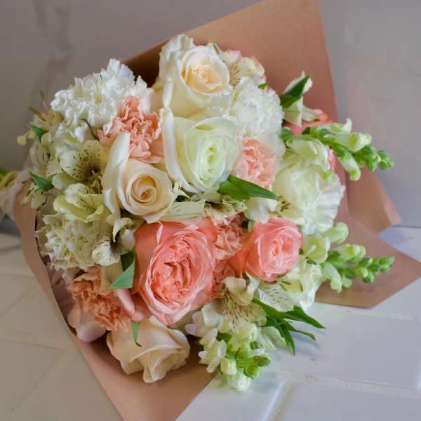 Bouquet of peach and white roses with white carnations and alstroemeria