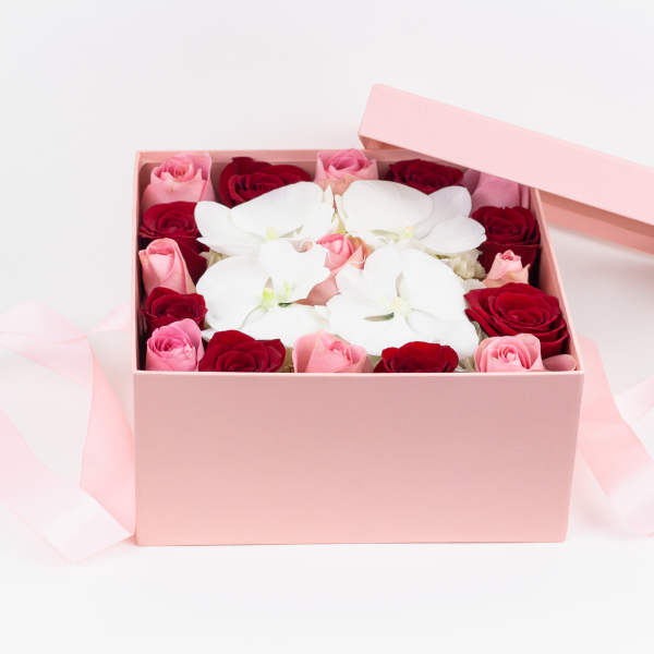 Pink gift box with red and pink roses and white orchids