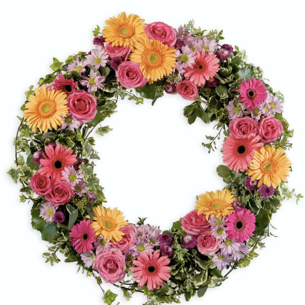 Heart-shaped floral wreath with pink and yellow blooms
