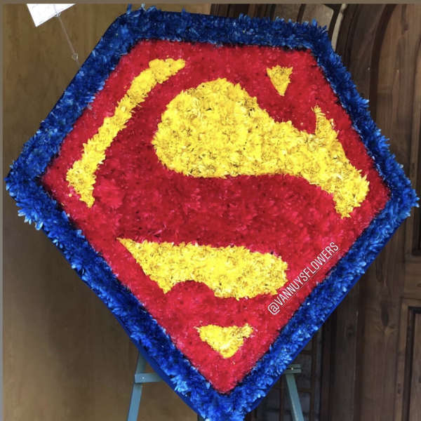 Superman logo floral tribute on an easel