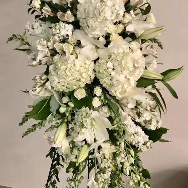 Tall white floral standing spray with lilies and hydrangeas