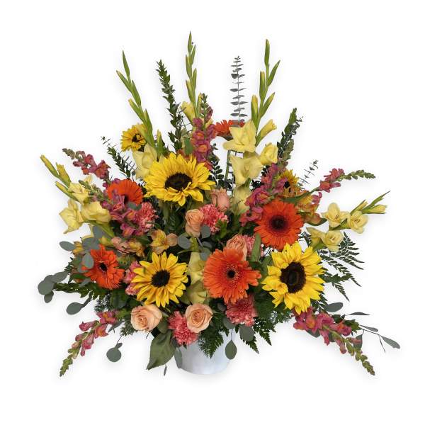 Large mixed bouquet with sunflowers, gerbera daisies, roses, and yellow gladiolus in a vase