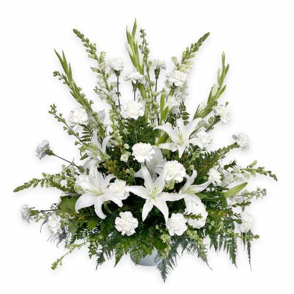 White lilies and carnations in a low vase arrangement