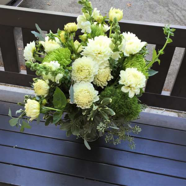 Bouquet of pale yellow and white flowers in a glass vase