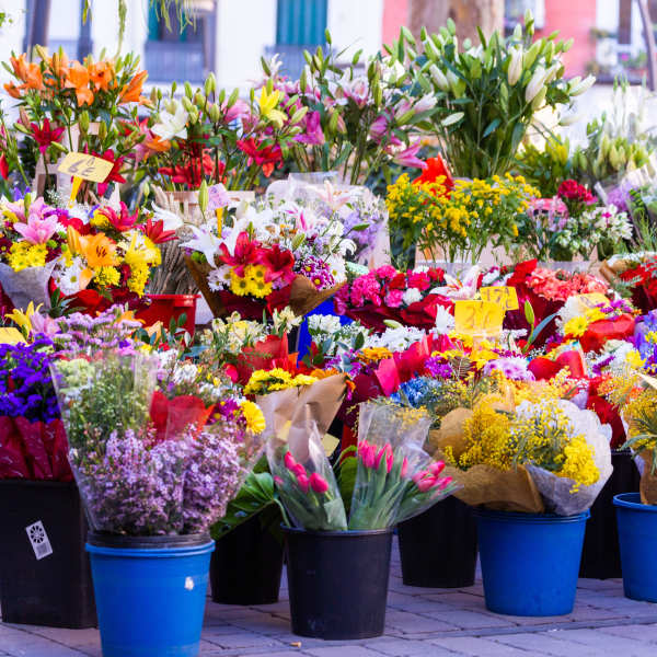 Outdoor flower market with colorful bouquets in buckets