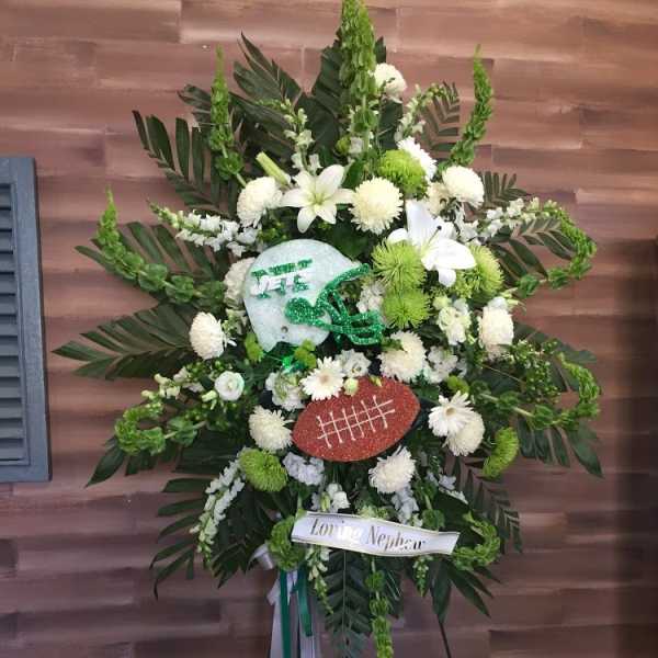 Football-themed standing floral spray with white and green flowers