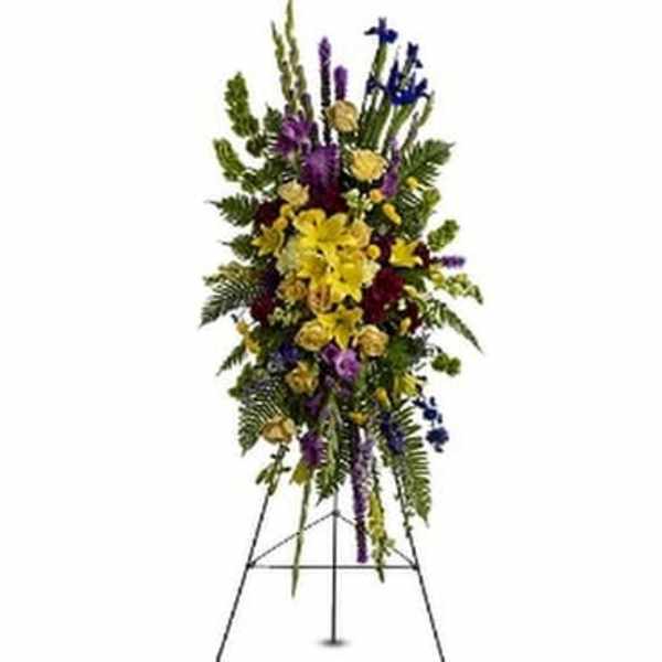 Tall standing floral spray with yellow, purple, and blue flowers