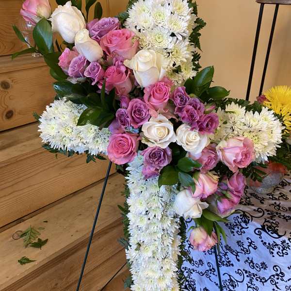 Standing floral cross with pink and white roses and white chrysanthemums