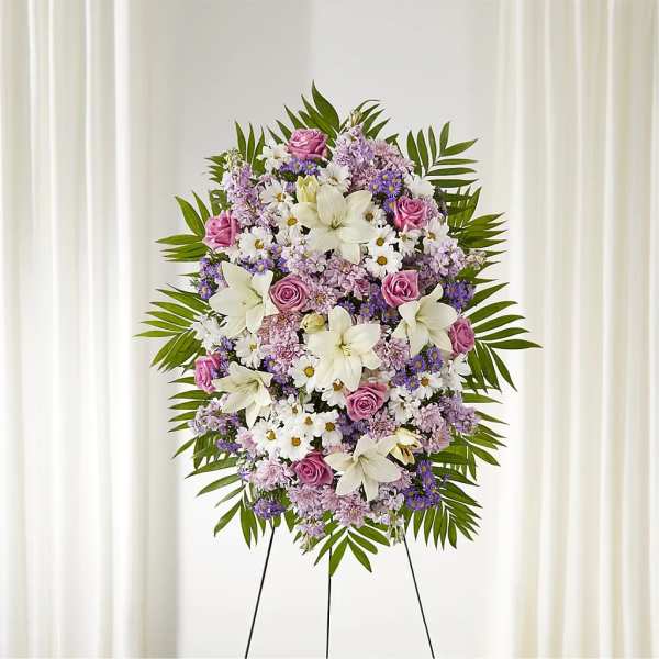 Standing floral spray with pink, white, and lavender flowers on an easel