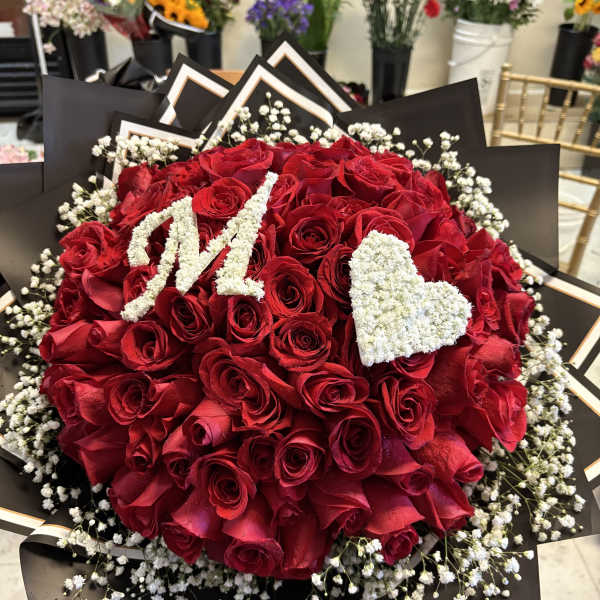 Red rose bouquet with white baby's breath and a white heart accent