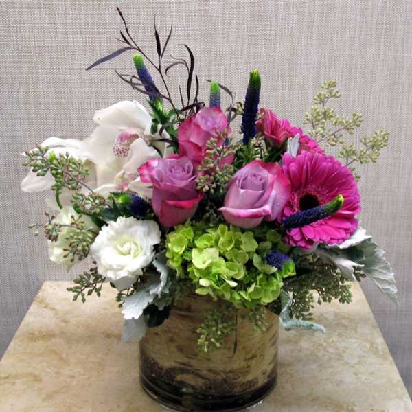 Pink and white flower arrangement in a glass vase