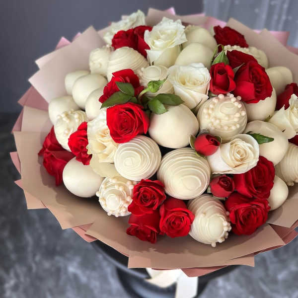 Bouquet of red and white roses with white decorative spheres
