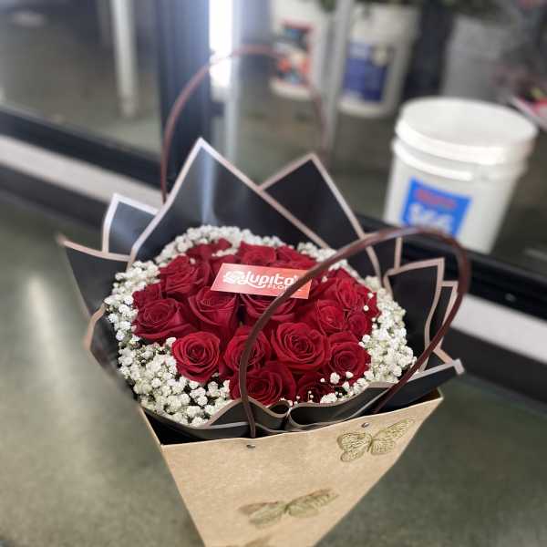 Bouquet of red roses with white baby's breath in a decorative wrap