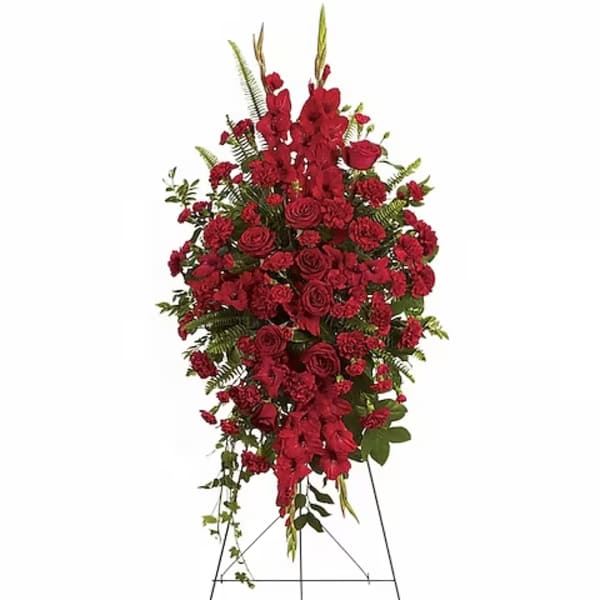 Standing spray of red roses and carnations on an easel