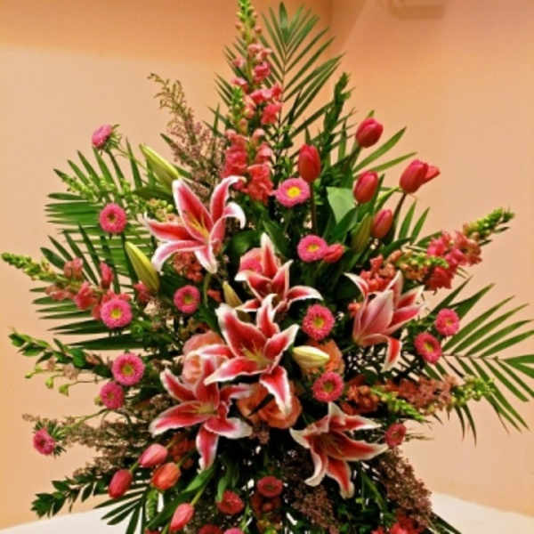 Tall floral standing spray with pink lilies and tulips