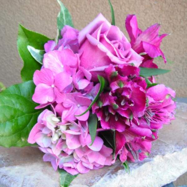 Pink rose and hydrangea bouquet with green leaves