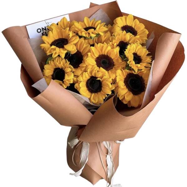 Bouquet of yellow sunflowers wrapped in brown paper