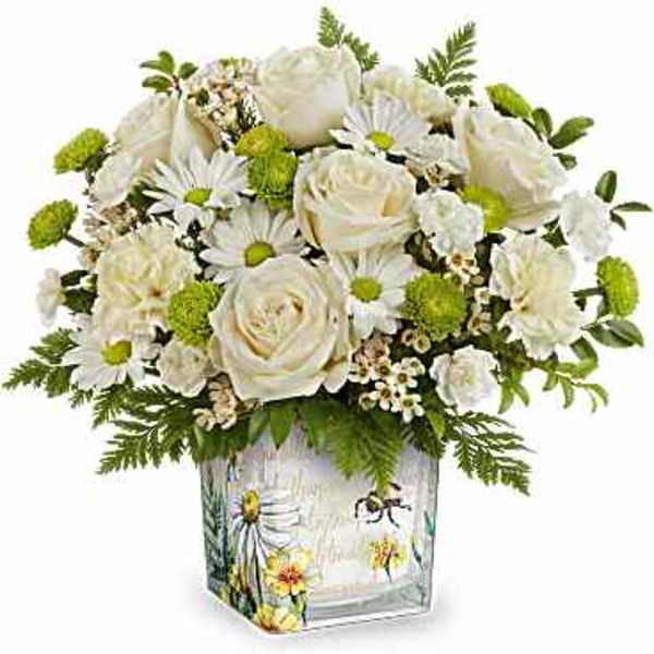 White roses and daisies in a decorated glass vase