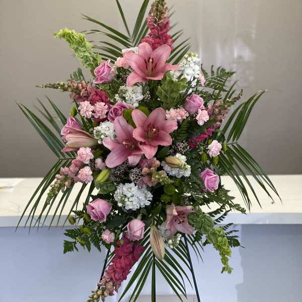 Pink lily and rose standing arrangement with palm fronds