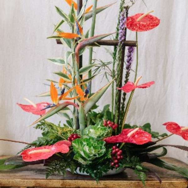 Tall tropical arrangement with bird of paradise and red anthuriums