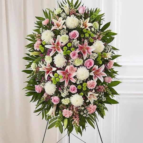 Standing floral spray with pink and white flowers on an easel