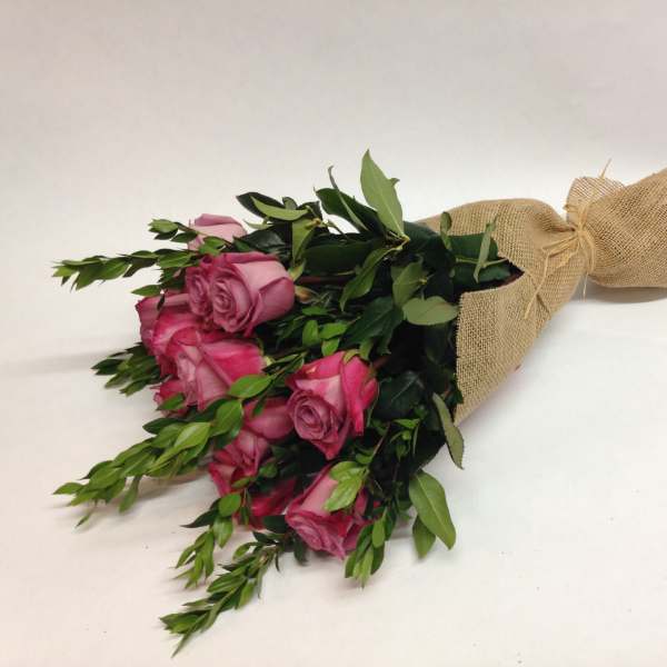 Bouquet of pink roses wrapped in burlap