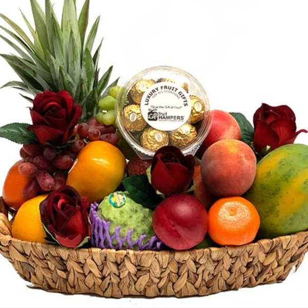 Fruit basket with roses and a box of chocolates