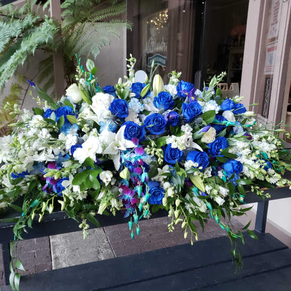Large blue and white floral arrangement with roses and lilies