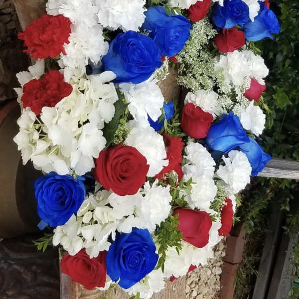 Bouquet of red, white, and blue roses with white carnations