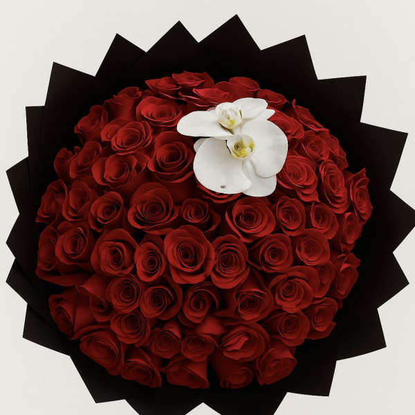 Round bouquet of red roses with white orchids on black wrap