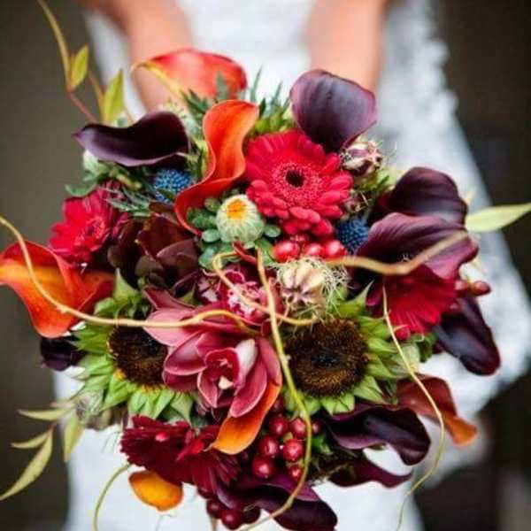 Bride holding a colorful bouquet with calla lilies and gerbera daisies