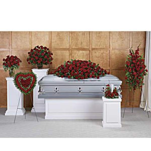 Funeral casket spray with red roses and matching standing arrangements