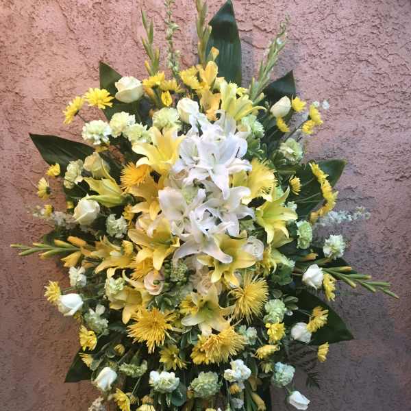 Yellow and white floral standing spray with lilies and roses