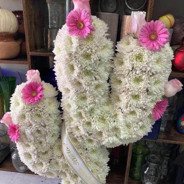 White chrysanthemum standing spray with pink gerbera daisies